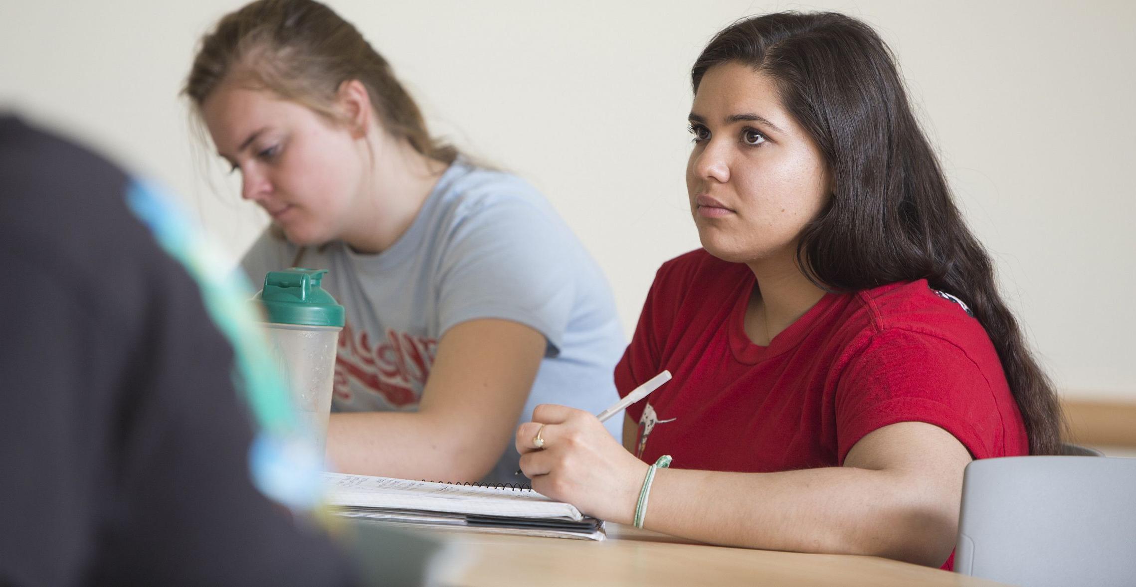 A student listens in on a class lecture. 